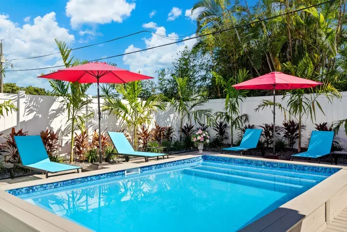 Don't feel like going to the beach? The fully fenced backyard offers a private tropical oasis.
