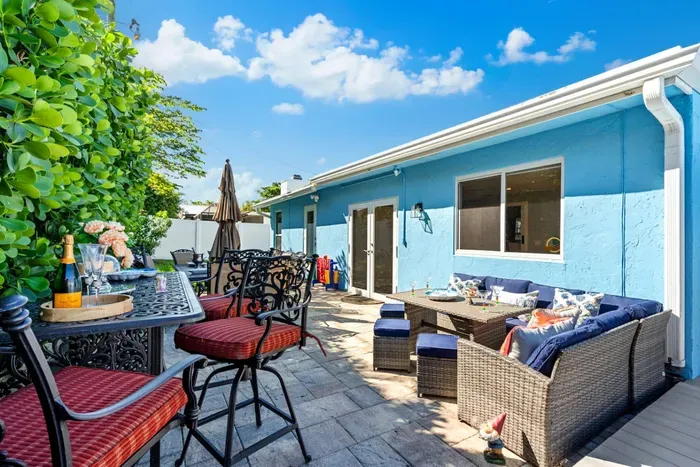 Lush plants and a colorful exterior add character to the entire space.