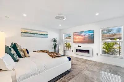This room continues the glamorous feeling with its subtle touches of style, with the natural light coming through both windows, brightening the space up through the day.