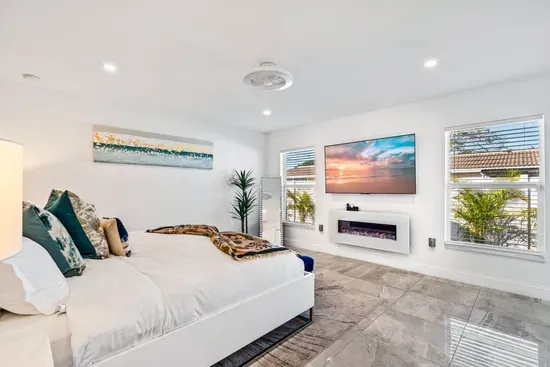 This room continues the glamorous feeling with its subtle touches of style, with the natural light coming through both windows, brightening the space up through the day.