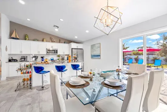 The dining area also has direct access to the outdoor patio area through glass sliding doors just behind.