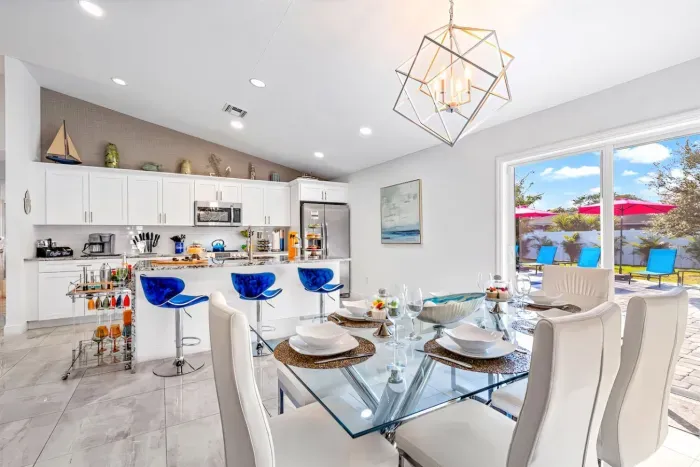 The dining area also has direct access to the outdoor patio area through glass sliding doors just behind.