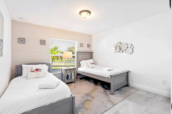 Lastly, bedroom number 3 fit with two modern and clean twin beds. With a bedside lamp separating them both. This room allows for everyone to have a comfortable place to sleep!