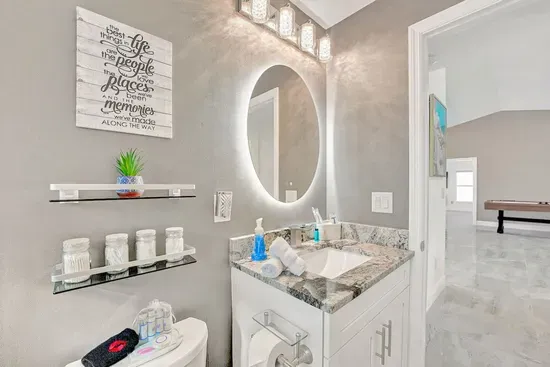 The stunning modern accent wallpaper combined with the tiling creates a luxurious feel whilst the sleek vanity area provides the perfect place to check yourself out in the LED lit mirror.