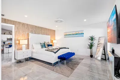 Make your way into the stylish bedrooms, the glorious flooring continues throughout the whole home. Welcoming you into the primary bedroom with its king sized bed and comfortable linens ready to wrap you up into a deep slumber.