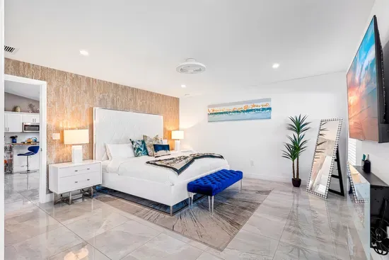 Make your way into the stylish bedrooms, the glorious flooring continues throughout the whole home. Welcoming you into the primary bedroom with its king sized bed and comfortable linens ready to wrap you up into a deep slumber.