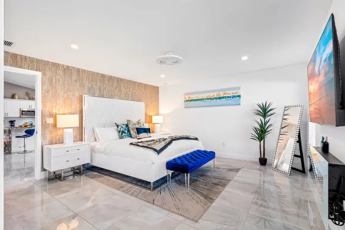 Make your way into the stylish bedrooms, the glorious flooring continues throughout the whole home. Welcoming you into the primary bedroom with its king sized bed and comfortable linens ready to wrap you up into a deep slumber.