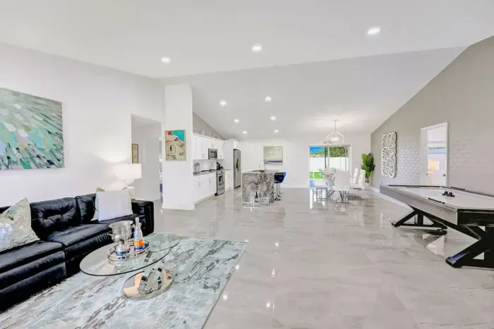 Welcome to your next glamorous newly constructed home! Starting off in the beautiful open plan living room with an air hockey table seamlessly flowing into the dining area and the kitchen underneath vaulted ceilings