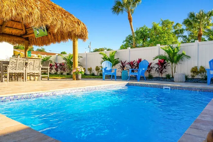 Cool off in the private swimming pool surrounded by lush tropical landscaping.