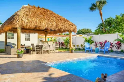 Are you ready for an unforgettable vacation in this stunning 3-bedroom house with a spacious swimming pool and a tiki hut?