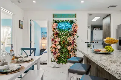 The neon sign on the colorful wall says it all!