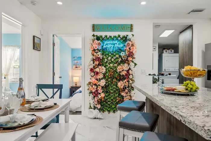 The neon sign on the colorful wall says it all!