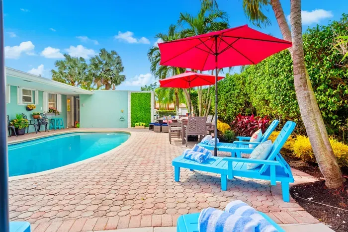 You'll want to extend your stay when you see the spacious, luxurious, and colorful pool backyard.