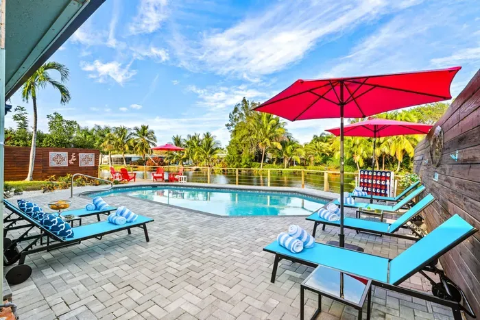 Resort-style canal-front backyard living with plenty of space for large groups to lounge, swim, and spend quality time together outdoors.