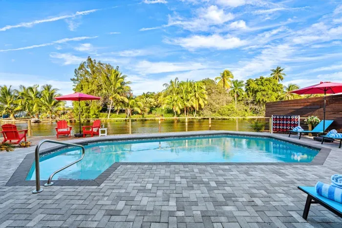 Experience the best of South Florida outdoor living with sunshine, palm-lined vibes, and a private backyard that opens to scenic canal views.