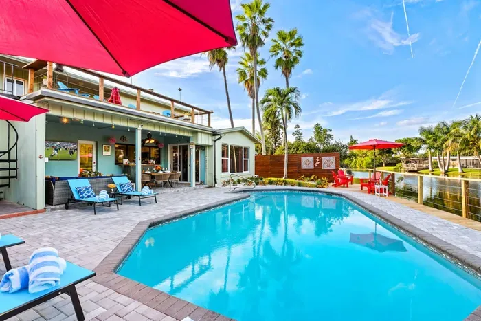 Stretch out with comfortable poolside seating and a spacious layout that makes this Fort Lauderdale waterfront backyard feel like your own private resort.