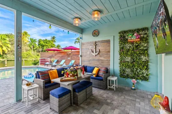 Lounge in the covered lanai with comfortable seating that keeps you cool and shaded while you enjoy the Fort Lauderdale breeze and poolside vibes.