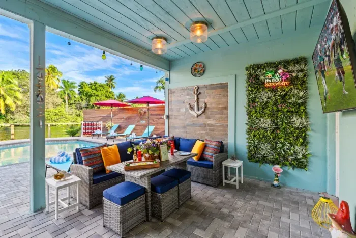 Lounge in the covered lanai with comfortable seating that keeps you cool and shaded while you enjoy the Fort Lauderdale breeze and poolside vibes.
