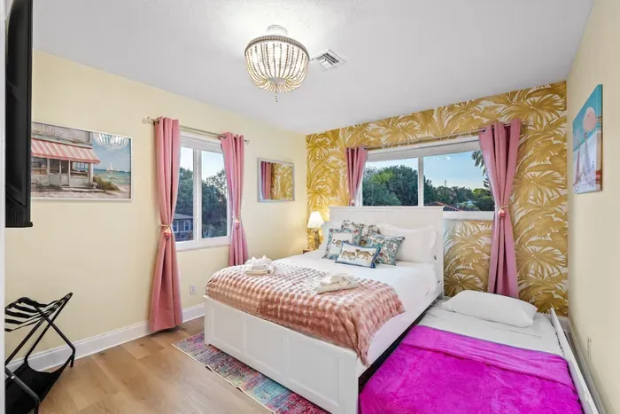 Queen bedroom with twin trundle for flexible group stays, ideal for families who want comfort, space, and easy sleeping options.