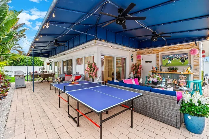 The outdoor ping pong table sits near the lounge area, allowing you to play a match between swims and poolside snacks.