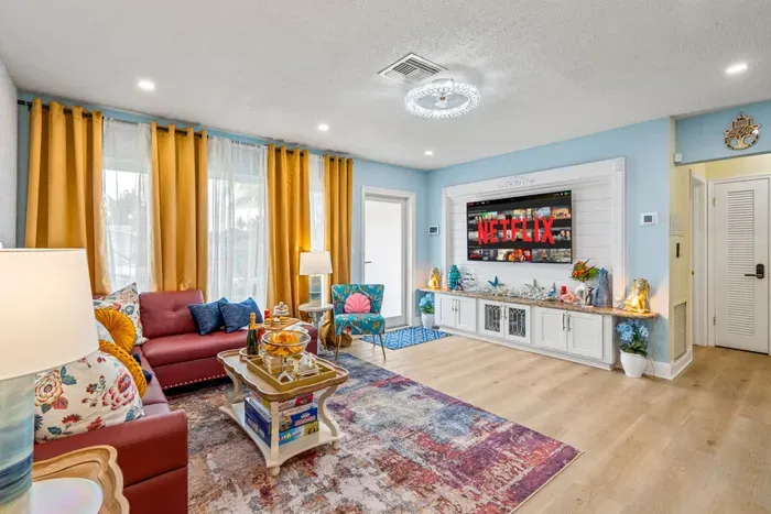 Welcome to the bright and comfortable living room perfect for movie nights, downtime, and reconnecting after beach days.