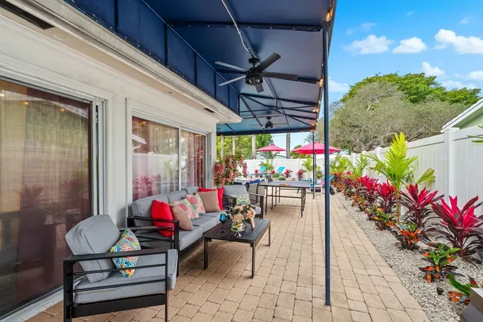 Family-friendly patio with easy access to the outdoor bar, lounge seating, and backyard games.
