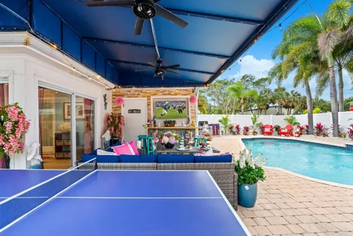 The backyard provides fun for everyone: ping pong, cornhole, and oversized Connect Four in one entertainment zone.