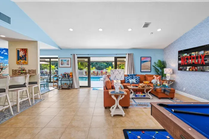 The open layout and elegant décor give this living room a luxurious yet relaxed vibe, perfect for a long weekend or extended stay in Delray Beach.