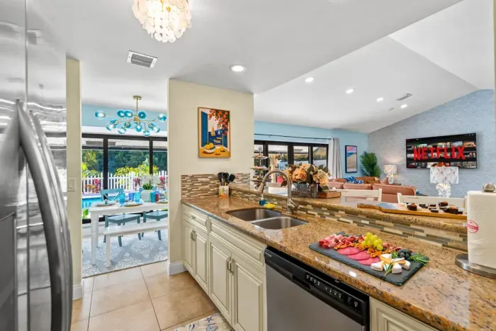 Cook like you're at home in the fully equipped kitchen with sleek appliances, white cabinets, and dark countertops, perfect for whipping up anything from beach snacks to full family dinners.