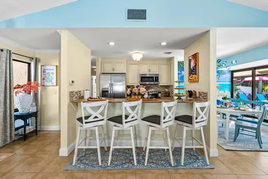 Start the day with a cup of coffee and a tasty breakfast in the center of the modern open-concept design living area.