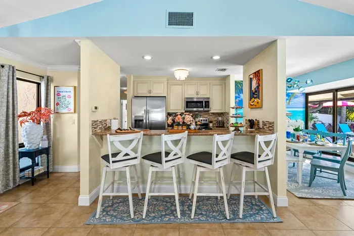 Start the day with a cup of coffee and a tasty breakfast in the center of the modern open-concept design living area.