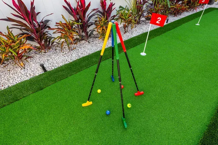 Spend the afternoon playing putt-putt in the backyard, a fun activity for both kids and adults between swims.