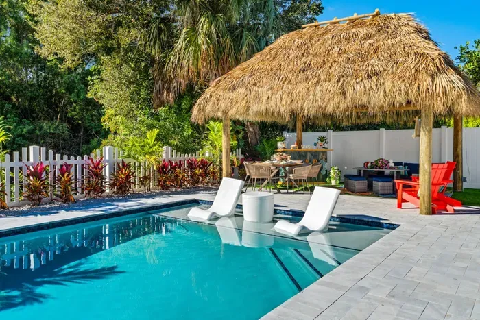 Step into your private backyard oasis with a heated swimming pool and spa, where you can float, soak, and unwind under the South Florida sun.