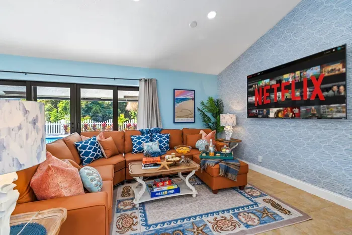 Cozy evenings come easy in this inviting living space, where soft lighting, a designer coffee table, and a huge smart TV create an authentic home-away-from-home feel.