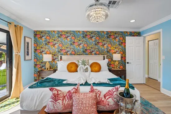 Drift off in the primary bedroom's king-size bed with premium linens and a 55" Roku smart TV, creating a private retreat after a day on the water.