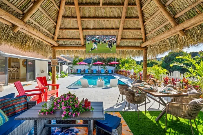 This fully loaded outdoor space—with heated pool, spa, canal, and games—feels like your own private resort in a quiet Delray Beach neighborhood.