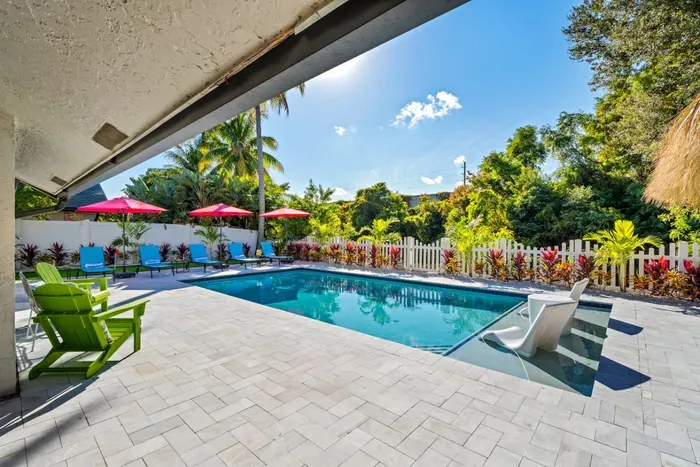 Whether you're sunbathing, grilling, or watching the kids splash in the pool, this backyard makes it easy to spend the whole day outside.