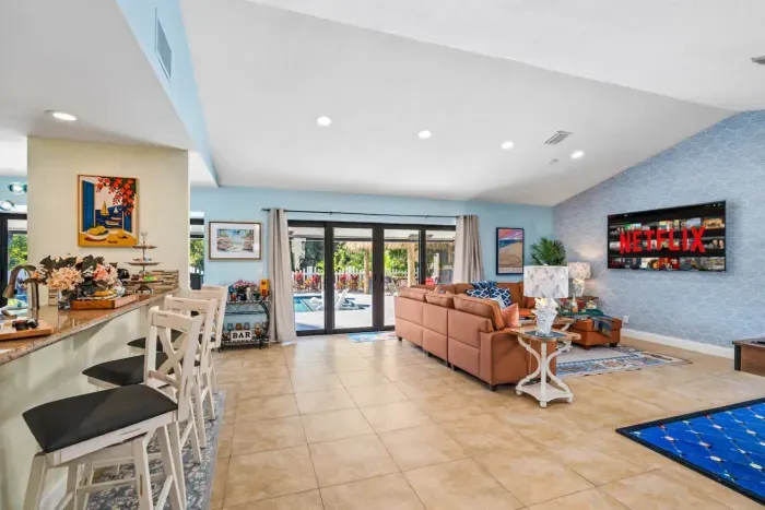 This modern living room is the ideal gathering place for families and groups, offering plenty of comfortable seating and entertainment for everyone.
