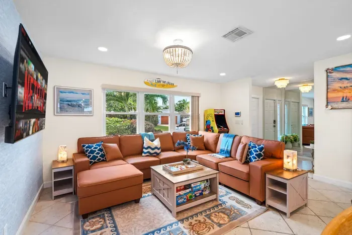 With plenty of seating, soft lighting, and laid-back décor, this living room is perfect for game nights, movie marathons, or simply catching up with loved ones.