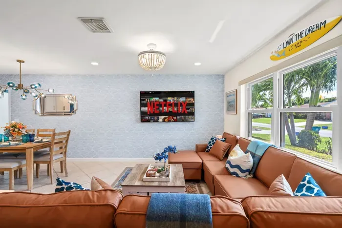 Kick back on the sectional, grab snacks from the kitchen, and enjoy a family movie night on the big-screen smart TV in this stylish modern living space.