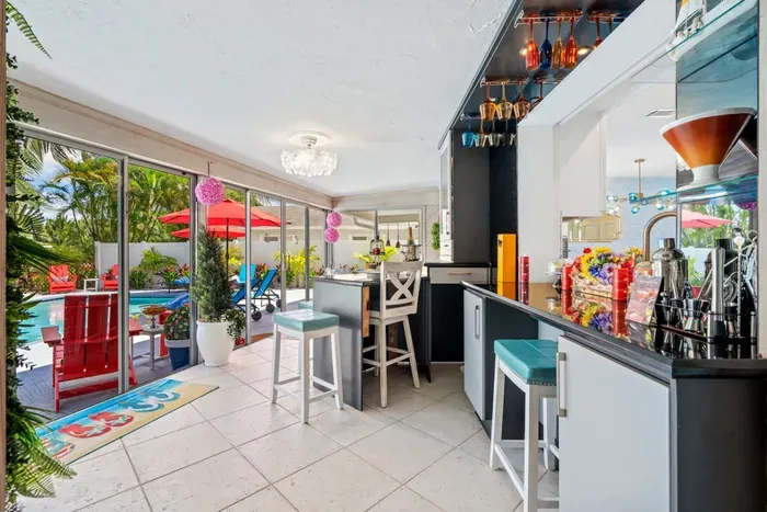 The bar is perfectly nestled next to the backyard, connecting the indoors with the outdoors in the most entertaining manner possible.