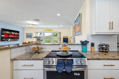 The open kitchen lets the designated chef stay part of the conversation while prepping dinner, with plenty of counter space for snacks, cocktails, and vacation favorites.
