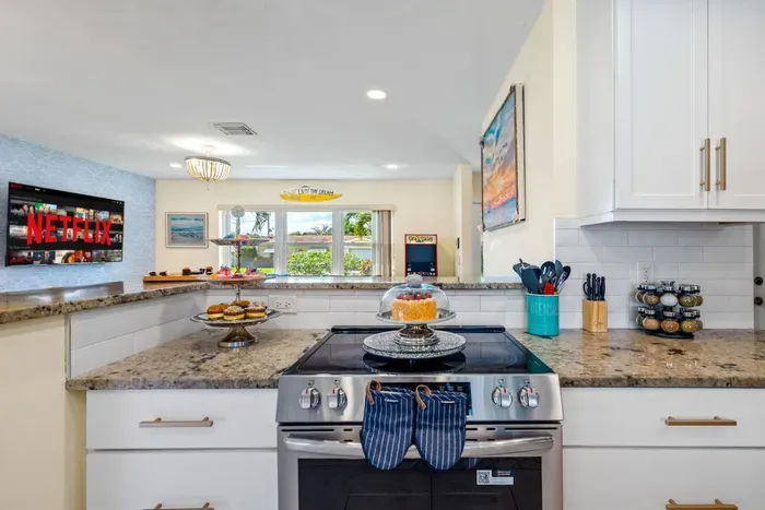 The open kitchen lets the designated chef stay part of the conversation while prepping dinner, with plenty of counter space for snacks, cocktails, and vacation favorites.