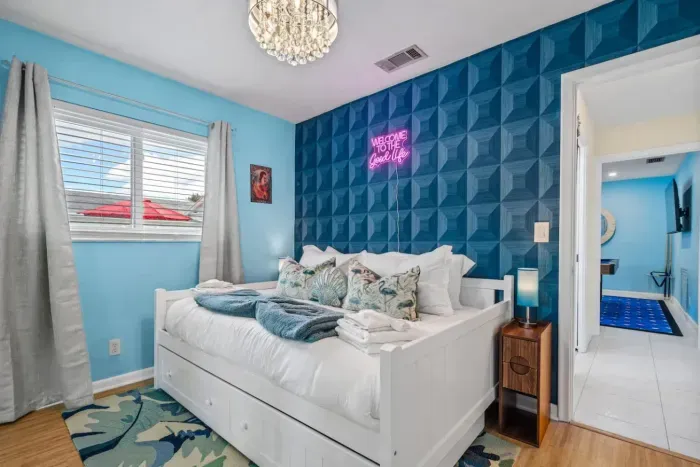 The fourth bedroom with a full-size daybed and trundle is ideal for kids, teens, or extra guests, offering a fun, flexible layout that still feels stylish.