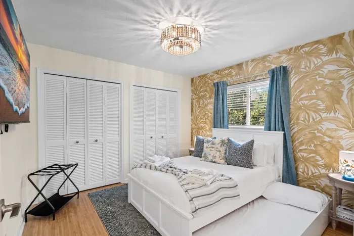 Soft bedside lighting and nightstands with reading lamps create a calm, cozy atmosphere for winding down with a book or scrolling through your vacation photos.