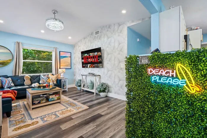 The green wall with a neon sign greets you as soon as you step inside, while also offering a perfect background for vacation photos.