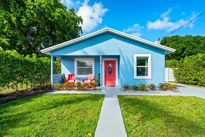 Follow the charming concrete pathway to the red doors!