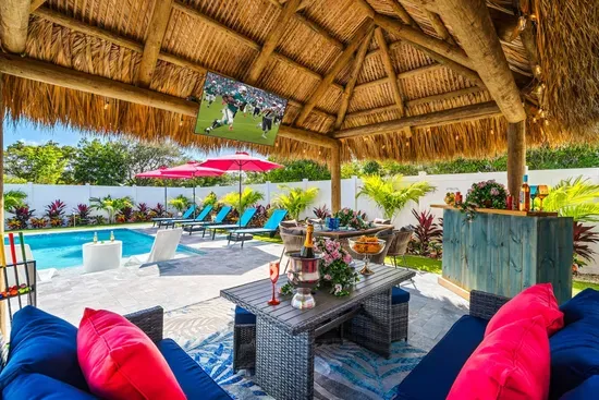 Relax under the covered pergola with a bar and dining area, ideal for outdoor meals and entertaining.
