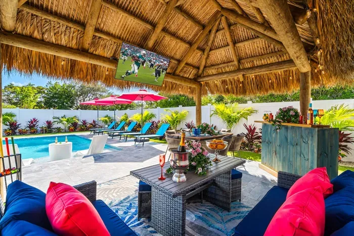 Relax under the covered pergola with a bar and dining area, ideal for outdoor meals and entertaining.
