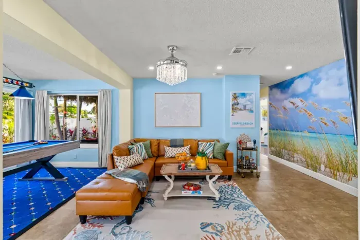 There's more than enough space for everyone on the comfy leather sofa below the luxurious chandelier that beautifully brightens up the space.